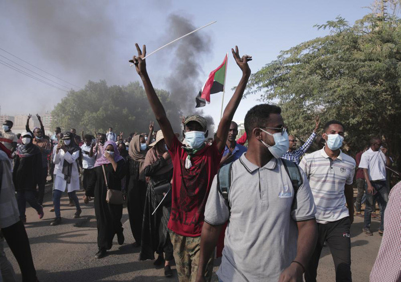 Sudanese protest against the military takeover, which upended the country’s fragile transition to democracy, in Khartoum, Sudan, Sunday, Nov. 21, 2021. Sudan’s military and civilian leaders signed a deal Sunday to reinstate Prime Minister Abdalla Hamdok, who was deposed in a coup last month. The country’s top general, Abdel Fattah Burhan, said in televised statements that Hamdok will lead an independent technocratic Cabinet until elections can be held. (AP File Photo)