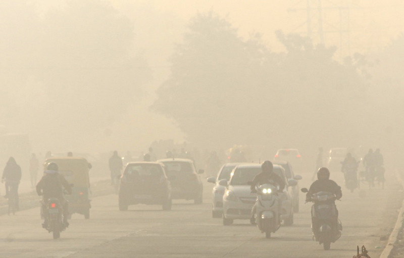 Vehicles ply on a road amid low visibility due smog, in Gurugram on November 24, 2021. (PTI Photo)