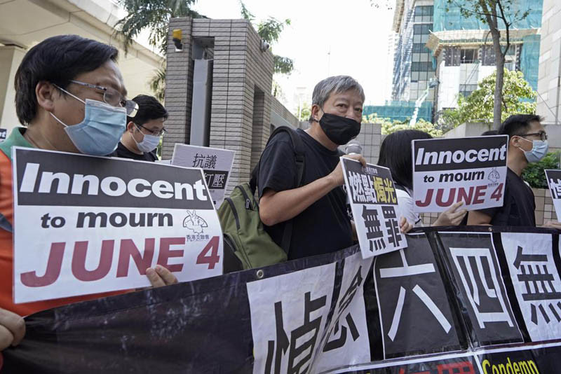 Pro-democracy activists, including Lee Cheuk-Yan, center, arrive at a court in Hong Kong on Oct. 15, 2020, after being charged of joining an unauthorized assembly on a vigil last June 4 to commemorate the anniversary of the 1989 Tiananmen crackdown. Trials began Monday, Nov. 1, 2021 for Hong Kong tycoon Jimmy Lai and seven other pro-democracy activists charged with inciting others to take part in last year's unauthorized Tiananmen vigil, amid a crackdown on political dissent in Hong Kong. (AP File Photo)