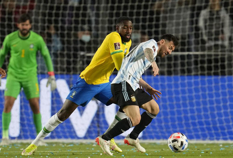 Argentina's Lionel Messi, right, is challenged by Brazil's Gerson during a qualifying soccer match for the FIFA World Cup Qatar 2022 at Bicentenario stadium in San Juan, Argentina on November 16, 2021. (AP Photo)