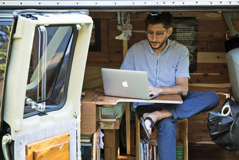 In this 2018, photo, U.S. journalist Danny Fenster works out of his van that he made into a home/office in Detroit. A court in Myanmar on November 3, 2021, rejected the bail application of Fenster, an American journalist jailed for the past five months in Myanmar, and added a new charge against him, his lawyer said. Fenster, 37, already was charged with incitement, also known as sedition, for allegedly spreading false or inflammatory information. That offense is punishable by up to three years in prison. (AP File Photo)