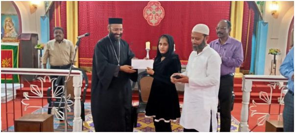 HSLC 2021 State topper (17th Rank), Amina Begum of the MGM Higher Secondary School being felicitated with Bishop Mar Theodosius meritorious award and cash prizes. (Photo Courtesy: Media Cell: MGOS)