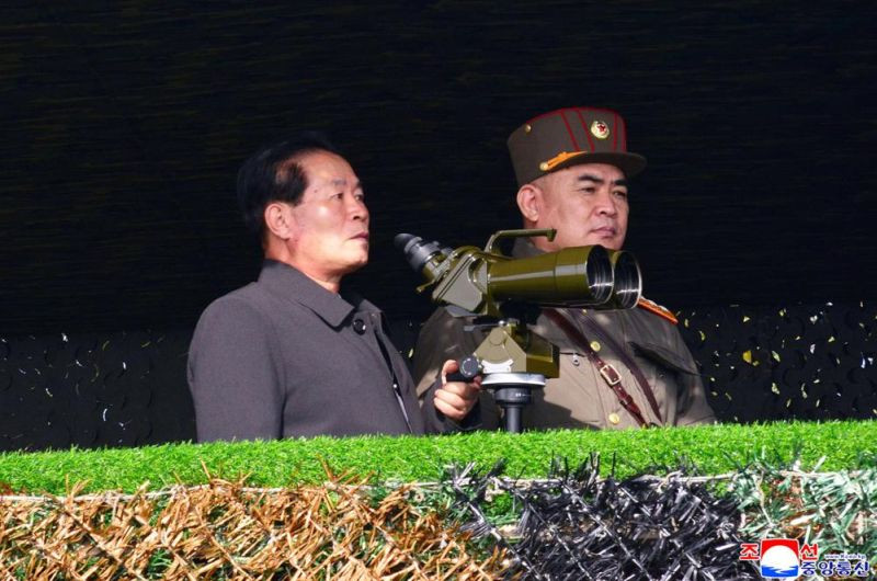 This photo provided by the North Korean government shows North Korean senior official Pak Jong Chon, left, inspects the army's artillery firing competition on November 6, 2021, in undisclosed location, North Korea. Independent journalists were not given access to cover the event depicted in this image distributed by the North Korean government. The content of this image is as provided and cannot be independently verified. Korean language watermark on image as provided by source reads: "KCNA" which is the abbreviation for Korean Central News Agency. (AP Photo)