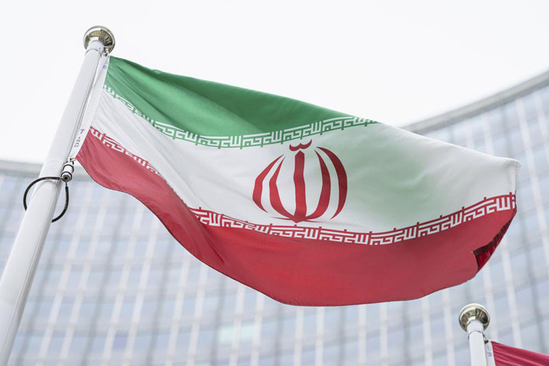 The flag of Iran waves in front of the the International Center building with the headquarters of the International Atomic Energy Agency, IAEA, in Vienna, AustriaI, May 24, 2021. On Monday, Nov. 29, 2021, negotiators are gathering in Vienna to resume efforts to revive Iran's 2015 nuclear deal with world powers, with hopes of quick progress muted after the arrival of a hard-line new government in Tehran led to a more than five-month hiatus. (AP File Photo)
