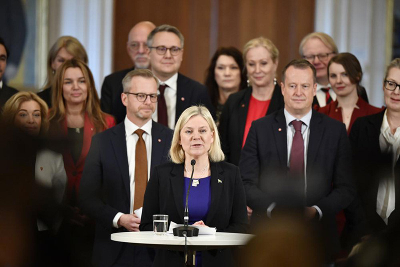 Swedish Prime Minister Magdalena Andersson, center, with her new cabinet members behind her, speaks during a press conference, in Stockholm, Tuesday, Nov. 30, 2021. Andersson, the first woman to ever hold that post in Sweden, has presented her one-party, minority government with only few changes compared to the previous one. (AP Photo)