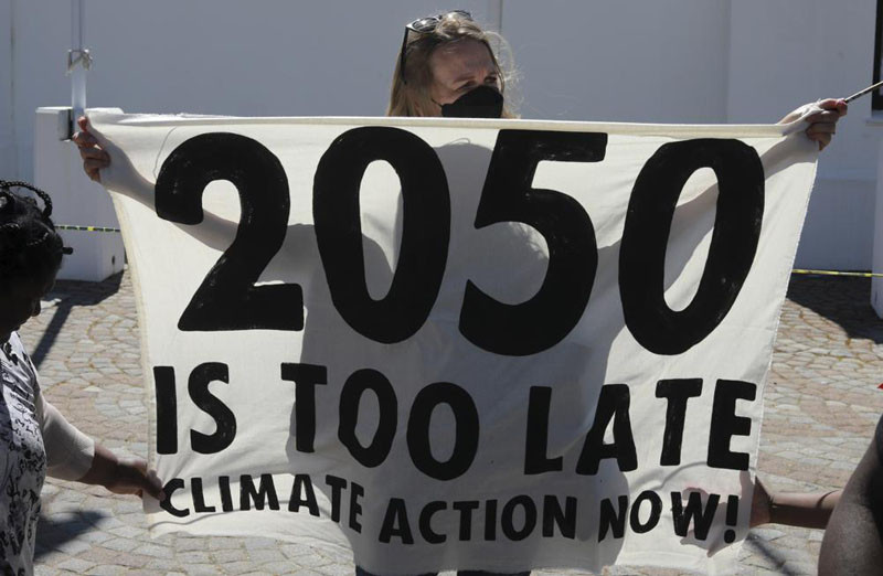 Activists protest for climate justice outside parliament in Cape Town, South Africa, Tuesday, Nov. 9, 2021. The protests coincides with the second week of as the COP26, UN Climate Summit in Glasgow. (AP Photo)