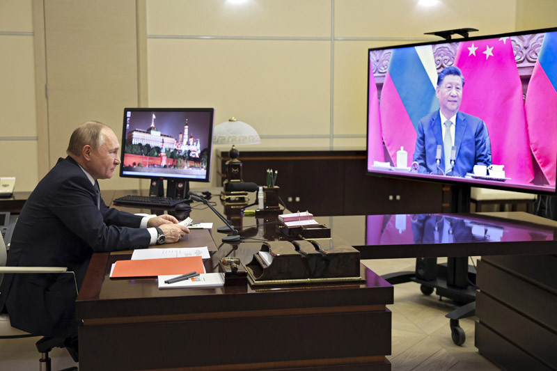 Russian President Vladimir Putin talks with Chinese President Xi Jinping via videoconference at the Novo-Ogaryovo residence outside Moscow, Russia on December 15, 2021. Chinese President Xi Jinping supported Russian President Vladimir Putin in his push to get Western security guarantees precluding NATO's eastward expansion, the Kremlin said Wednesday after the two leaders held a virtual summit. Putin and Xi spoke as Moscow faces heightened tensions with the West over a Russian troop buildup near Ukraine's border. (AP/PTI Photo)