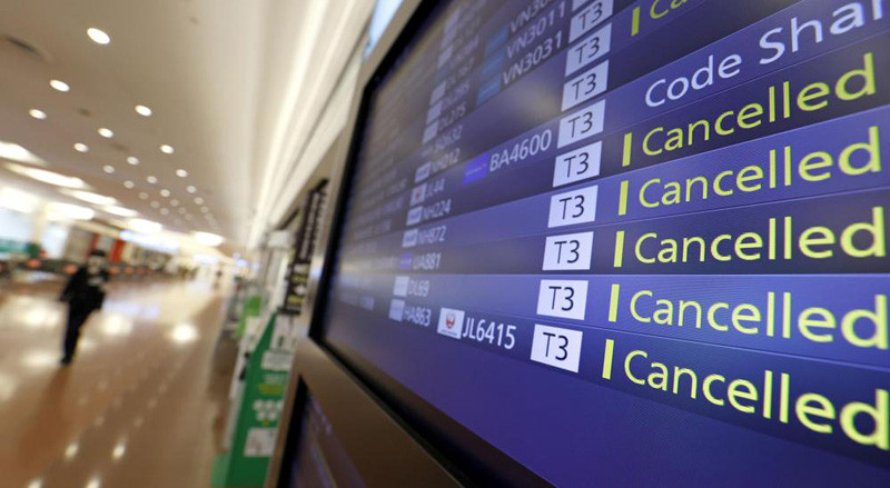 Flight cancelations are seen on the information board at Haneda Airport in Tokyo, Japan, Tuesday, Nov. 30, 2021. NHK TV said Wednesday, Dec. 1, that Japan will suspend new reservations on all incoming flights for a month to guard against new virus variant. (AP Photo)
