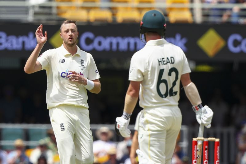 Brisbane : England's Ollie Robinson, left, reacts after bowling to Australia's Travis Head during day three of the first Ashes cricket test at the Gabba in Brisbane, Australia, Friday, Dec. 10, 2021.  AP/PTI