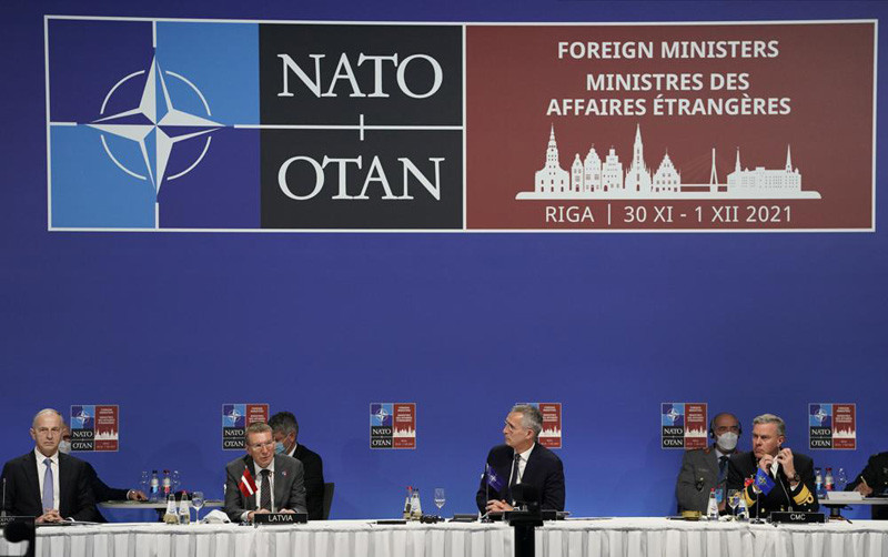 NATO Secretary General Jens Stoltenberg, second right, Minister of Foreign Affairs of Latvia Edgars Rinkevics, second left, NATO Chair of the Military Committee Admiral Rob Bauer, right, and NATO Deputy Secretary General Mircea Geoana attend the NATO Foreign Ministers meeting in Riga, Latvia, Tuesday, Nov. 30, 2021. (AP Photo)