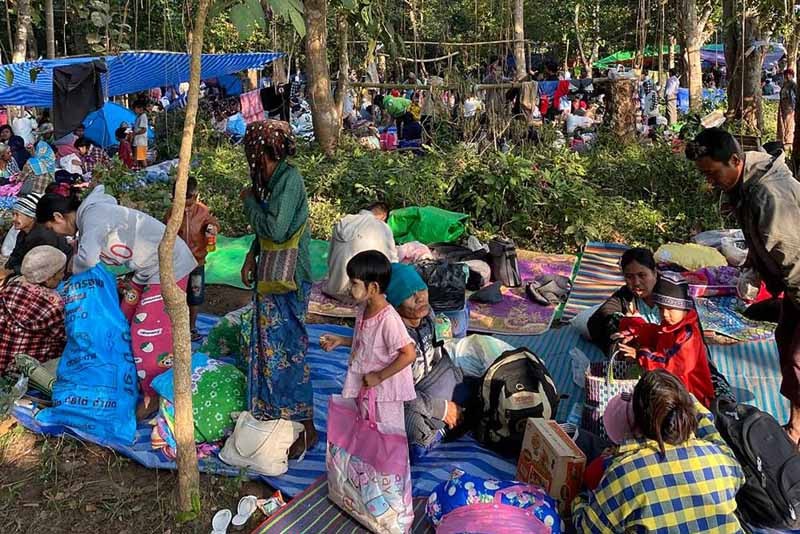 In this photo provided by Thailand's Ministry of Defense taken during the third week of Dec. 2021, Myanmar villagers rest in an evacuation area in Thailand after fleeing clashes between Myanmar troops and an ethnic Karen rebel group in Mae Sot, Tak province, northern Thailand. Fighting between Myanmar government forces and ethnic guerrillas has sent about 4,200 villagers fleeing across the border into Thailand over the past week, a Thai army officer said Wednesday. (AP Photo)