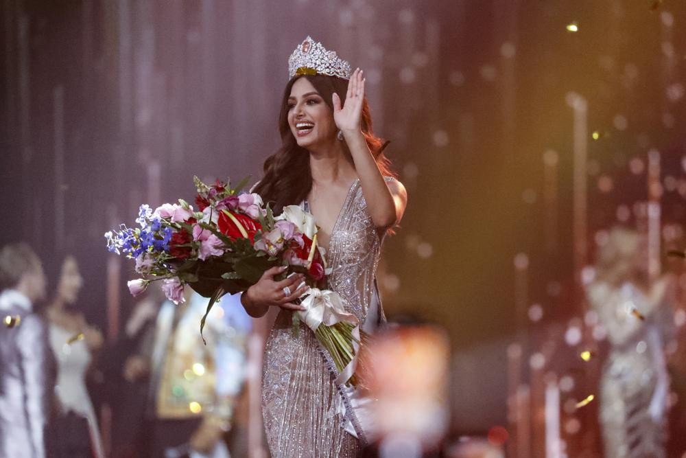 India s Harnaaz Sandhu waves after being crowned Miss Universe 2021 during the 70th Miss Universe pageant, Monday, Dec. 13, 2021, in Eilat, Israel. (AP Photo/Ariel Schalit)