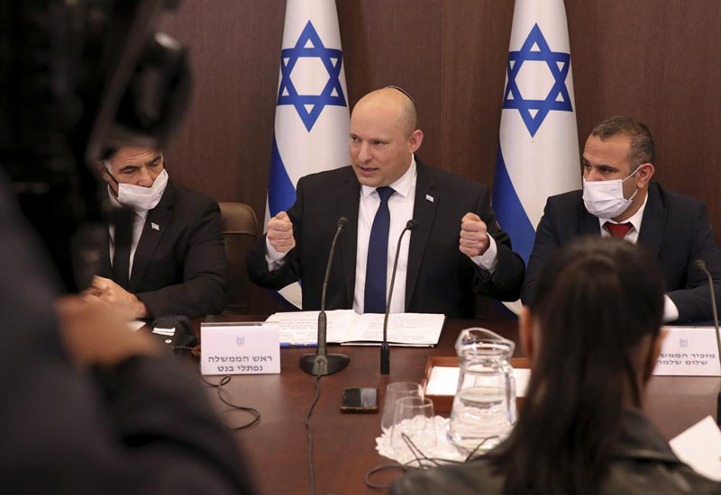 Israeli Prime Minister Naftali Bennett, center, chairs a weekly cabinet meeting, at the prime minister's office in Jerusalem, Sunday, Dec. 5, 2021. Bennett on Sunday urged world powers to take a hard line against Iran in negotiations to curb the country's nuclear program, as his top defense and intelligence officials headed to Washington amid the flailing talks. (AP Photo)