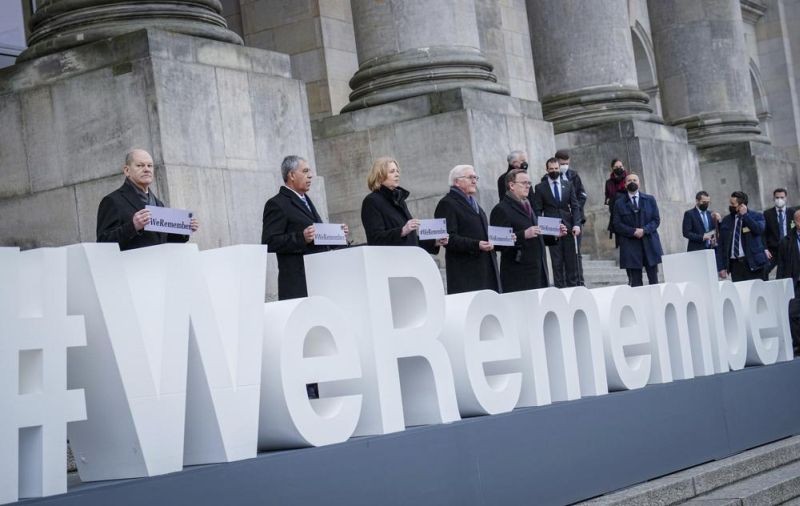 German Chancellor Olaf Scholz, Mickey Levy, Speaker of the Knesset, Bärbel Bas, President of the Bundestag, German President Frank-Walter Steinmeier and Bodo Ramelow, Prime Minister of Thuringia and President of the Bundesrat, from left, stand in front of the Reichstag building after the memorial hour for the "Day of Remembrance of the Victims of National Socialism" at the lettering "#weremember" (We remember) in Berlin, Germany, Thursday, Jan.27, 2022. (AP Photo)