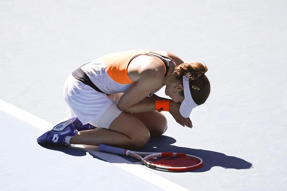 Alize Cornet of France reacts after defeating Simona Halep of Romania in their fourth round match at the Australian Open tennis championships in Melbourne, Australia, Monday, Jan. 24, 2022.(AP Photo/Andy Brownbill)
