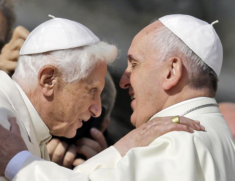 Pope Francis, right, hugs Pope Emeritus Benedict XVI prior to the start of a meeting with elderly faithful in St. Peter's Square at the Vatican, Sunday, Sept. 28, 2014. A long-awaited report on sexual abuse in Germany’s Munich diocese on Thursday faulted retired Pope Benedict XVI’s handling of four cases when he was archbishop in the 1970s and 1980s. (AP File Photo)