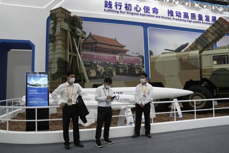 Workers wearing masks stand near missiles produced by China Aerospace Science and Industry Corp.displayed during the 13th China International Aviation and Aerospace Exhibition, also known as Airshow China 2021 on  September 28, 2021 in Zhuhai in southern China's Guangdong province. China on Friday, Jan. 21, 2022 criticized Washington for imposing sanctions on Chinese companies the U.S. says exported missile technology and accused the United States of hypocrisy for selling nuclear-capable cruise missiles. (AP File Photo)