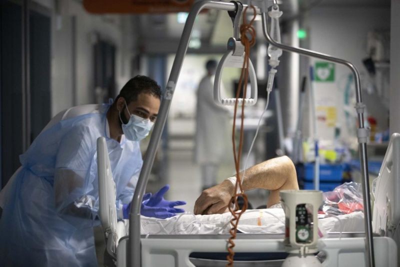 A medical staff member speaks with a COVID-19 patient in the infectious disease ward of the Strasbourg University Hospital, eastern France, Thursday Jan. 13, 2022. The omicron variant is exposing weaknesses at the heart of Europe's public health system. In France and Britain, a sharp rise in coronavirus hospitalizations coupled with staff falling sick has led to a shortage of beds. (AP Photo)