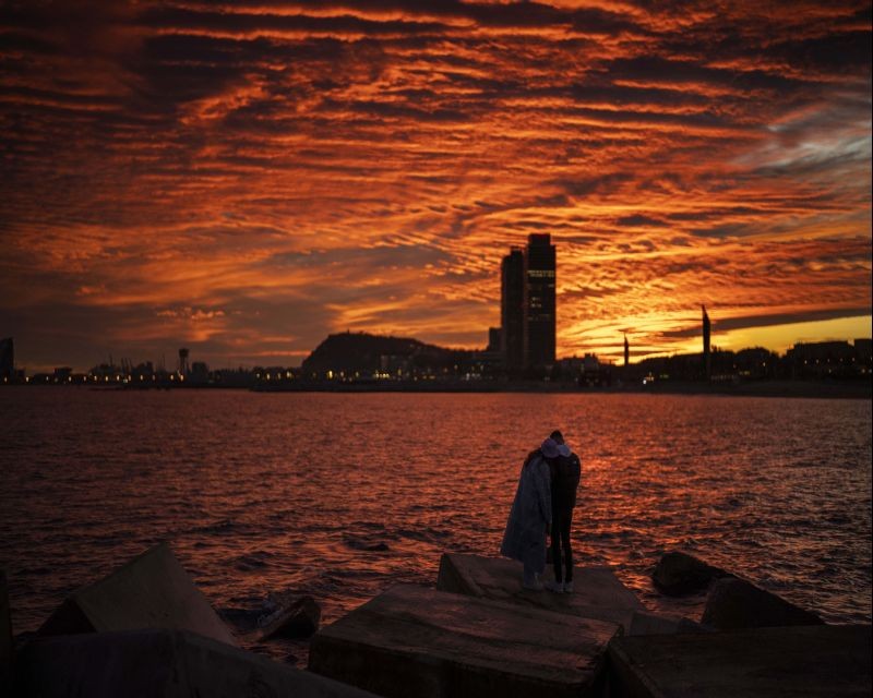 Barcelona: A couple watch as the sun sets from a breakwater in Barcelona, Spain, Saturday, Jan. 8, 2022.AP/PTI(