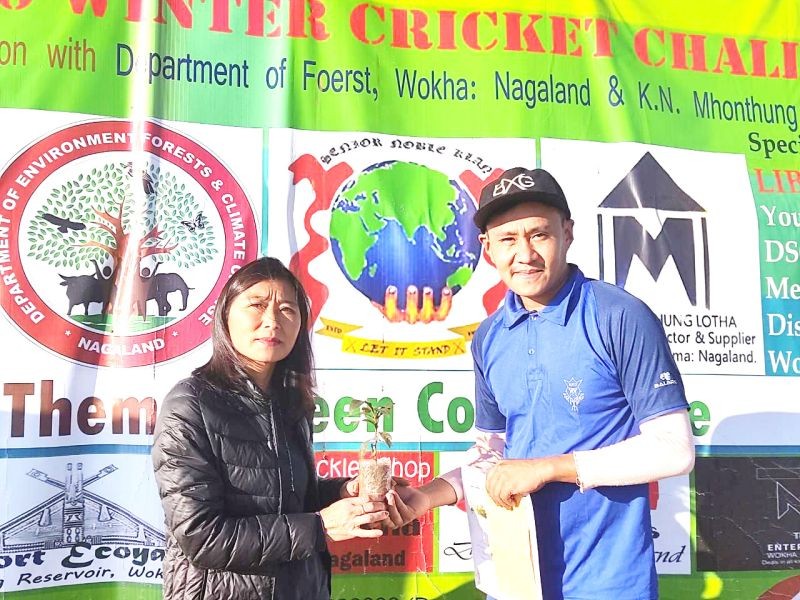 Abi Humtsoe, General Secretary Wokha District Women Sports Association seen handing the man of the match award to Among of Triton CC.