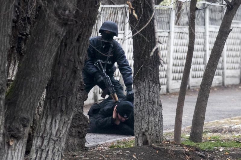 An armed riot police officer detains a protester during a security anti-terrorists operation in a street after clashes in Almaty, Kazakhstan, Saturday, Jan. 8, 2022. Kazakhstan's president authorized security forces on Friday to shoot to kill those participating in unrest, opening the door for a dramatic escalation in a crackdown on anti-government protests that have turned violent. The Central Asian nation this week experienced its worst street protests since gaining independence from the Soviet Union three decades ago, and dozens have been killed in the tumult. (AP Photo)