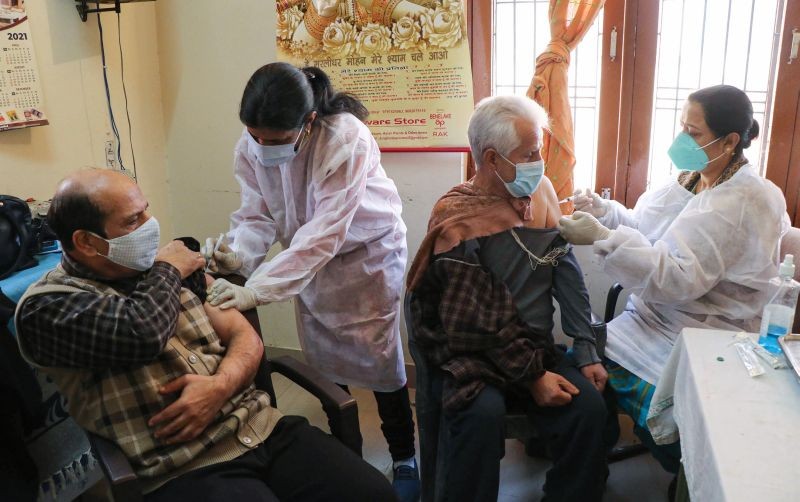 Healthcare workers administer a booster dose of the Covid-19 vaccine to senior citizens at a vaccination center in Jammu on January 28, 2022. (PTI Photo)