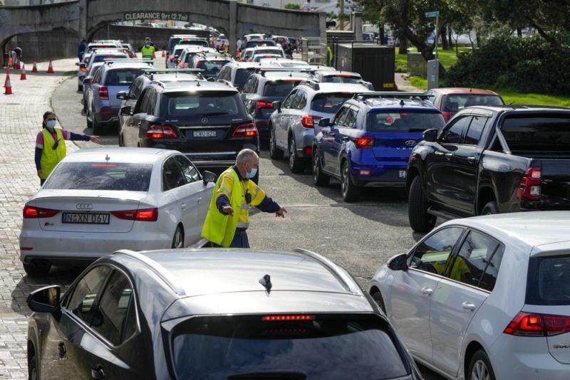 Traffic marshals direct vehicles at a drive-thru COVID-19 testing clinic at Bondi Beach in Sydney, Australia, on Jan. 8, 2022. Australia on Friday, Jan. 21, reported its deadliest day of the pandemic with 80 coronavirus fatalities, as an outbreak of the omicron variant continued to take a toll. (AP File Photo)