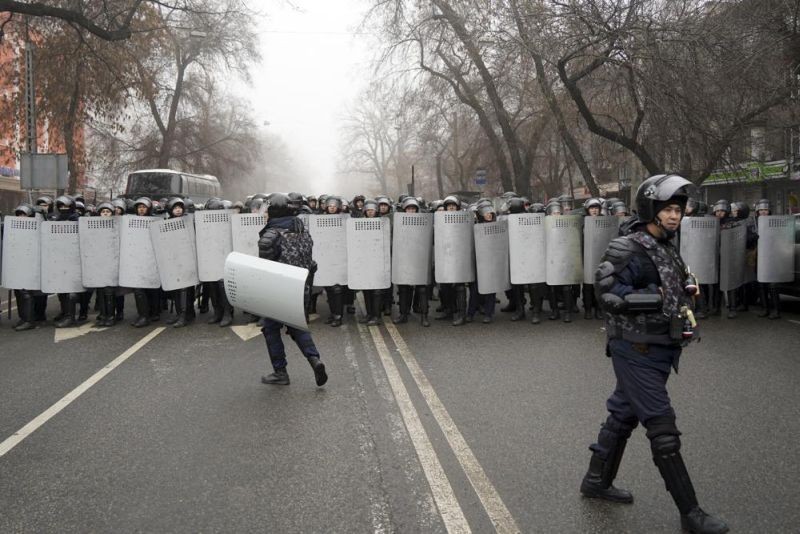 Riot police officers stand ready to stop demonstrators during a protest in Almaty, Kazakhstan on January 5, 2022. Demonstrators protesting rising fuel prices have broken into the mayor's office in Kazakhstan's largest city and flames were seen coming from inside, according to local news reports. Protests against a sharp increase in prices for liquefied gas began this week in the country's west and spread to Almaty and the capital Nur-Sultan. (AP Photo)