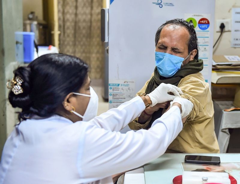 A healthworker administers a dose of COVID-19 vaccine to a beneficiary in New Delhi on January 20, 2022. (PTI Photo)