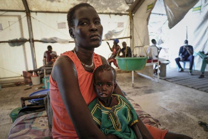 Nyayiar Kuol holds her severely malnourished 1-year-old daughter Chuoder Wal in a hospital run by Medicines Sans Frontieres (Doctors Without Borders) in Old Fangak in Jonglei state, South Sudan Tuesday, Dec. 28, 2021. Aid groups say more people than ever in the country will face hunger this year, because of the worst floods in 60 years as well as conflict and the sluggish implementation of the peace agreement that has denied much of the country basic services. (AP Photo)