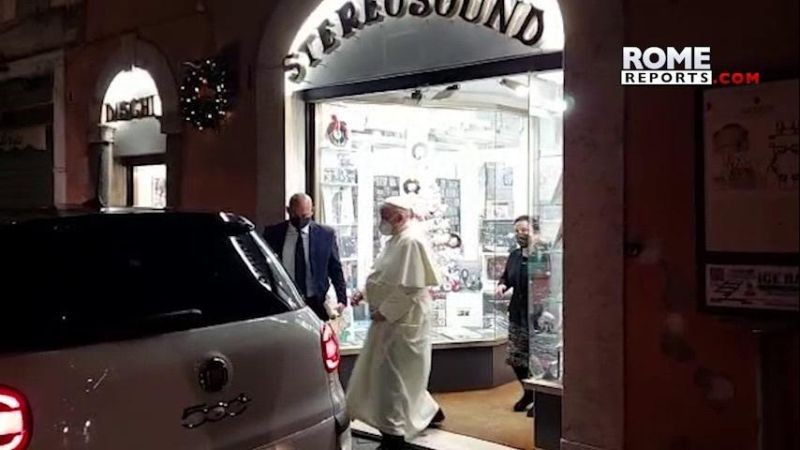 In this image from video made available by Javier Martinez Brocal of Rome Reports, Pope Francis leaves a record shop in Rome, Tuesday, Jan. 11, 2022. Pope Francis grew up listening to the opera on the radio, is a fan of tango and milonga and thinks Mozart "lifts you to God." But it still came as a something of a shock to see him coming out of a downtown Rome record shop Tuesday evening with a CD in hand, after making an unannounced visit that was caught on camera by a Vatican reporter who happened to be nearby. (AP Photo)