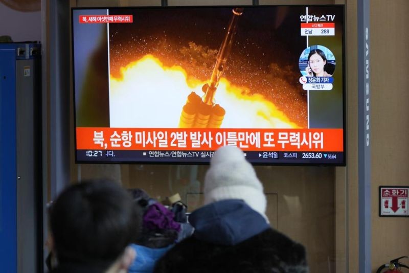 People watch a TV screen showing a news program reporting about North Korea's missile launch with a file image, at a train station in Seoul, South Korea, Thursday, Jan. 27, 2022. North Korea on Thursday fired at least two suspected ballistic missiles into the sea in its sixth round of weapons launches this month, South Korea's military said. The letters read "North, fired two missiles." (AP Photo)