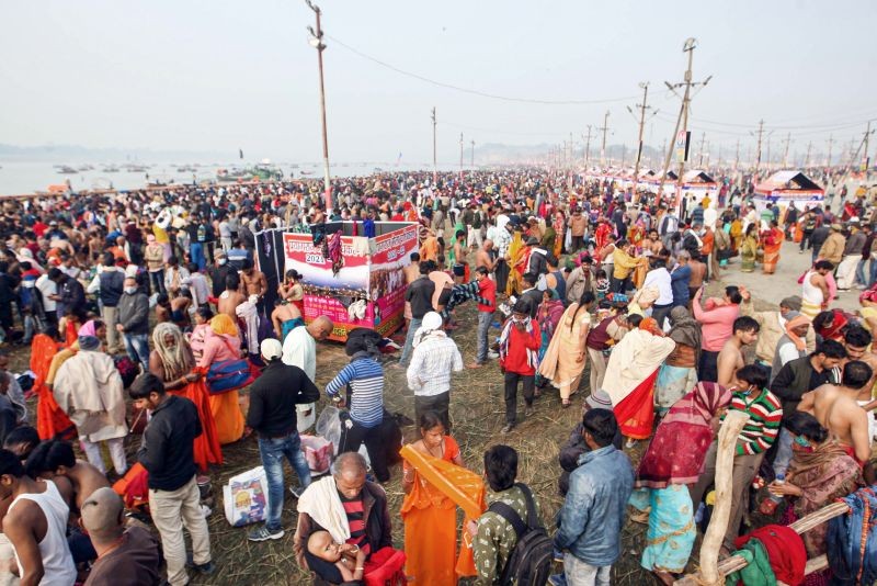 Devotees gather to take a 'holy dip' in the River Ganga on the occasions of 'Makar Sankranti' festival during the ongoing 'Magh Mela' festival at Sangam in Prayagraj on January 14, 2022.  (PTI Photo)