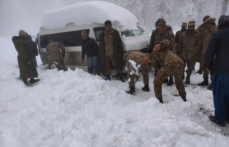 In this photo provided by the Inter Services Public Relations, army troops take part in a rescue operation in a heavy snowfall-hit area in Murree, some 28 miles (45 kilometers) north of the capital of Islamabad, Pakistan on January 8, 2022. Temperatures fell to minus 8 degrees Celsius (17.6 Fahrenheit) amid heavy snowfall at Pakistan's mountain resort town of Murree overnight, killing multiple people who were stuck in their vehicles, officials said Saturday. (AP/PTI Photo)
