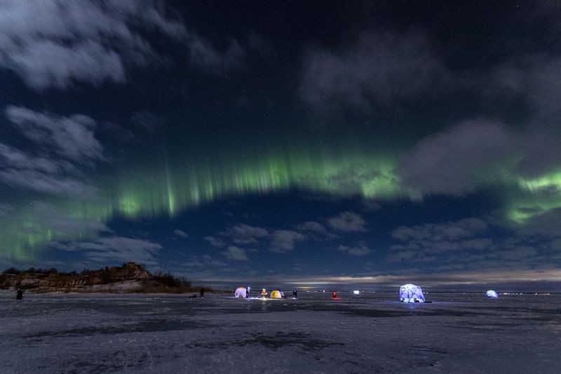 The northern lights, or aurora borealis, illuminate the night sky above fishermen on the ice of Finnish Gulf outside St. Petersburg, Russia on January 15, 2022. (AP/PTI Photo)