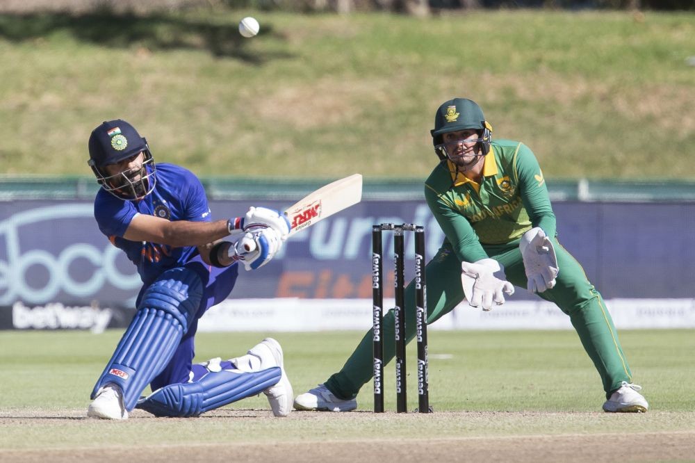 Paarl: Indian batsman Virat Kohli plays a shot while South African wicket keeper Quinton De Kock looks on during the first ODI match between South Africa and India in Paarl, South Africa, Wednesday, Jan. 19, 2022. AP/PTI Photo