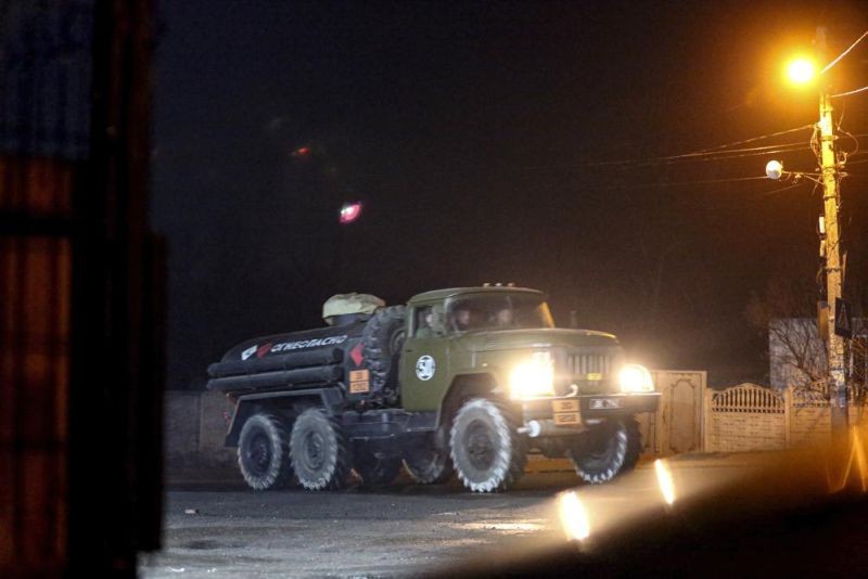 A military truck drives down a street outside Donetsk, the territory controlled by pro-Russian militants, eastern Ukraine, late Tuesday, Feb. 22, 2022. Europe braced for further confrontation Wednesday, Feb. 23, 2022, after tensions over Ukraine escalated dramatically when Russian President Vladimir Putin got the OK to use military force outside his country and the West responded with sanctions. (AP Photo)