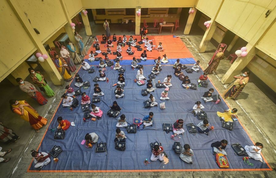 Kolkata: Students attend the first day of class at 'Paray Sikshalaya', an outdoor learning initiative started by the West Bengal Government to follow all Covid-19 protocols for students under VIII standard, in Kolkata, Monday, Feb. 7, 2022. (PTI Photo/Swapan Mahapatra)