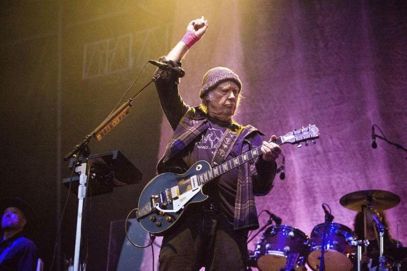 In this May 25, 2019, photo, Neil Young performs at the BottleRock Napa Valley Music Festival at Napa Valley Expo in Napa, Calif. Following protests of Spotify kicked off by Young over the spread of COVID-19 vaccine misinformation, the music streaming service said on January 30, 2022, that it will add content advisories before podcasts discussing the virus. The singer on January 26, had his music removed from Spotify after the tech giant declined to remove episodes of “The Joe Rogan Experience,” which has been criticized for spreading virus misinformation. (AP File Photo)