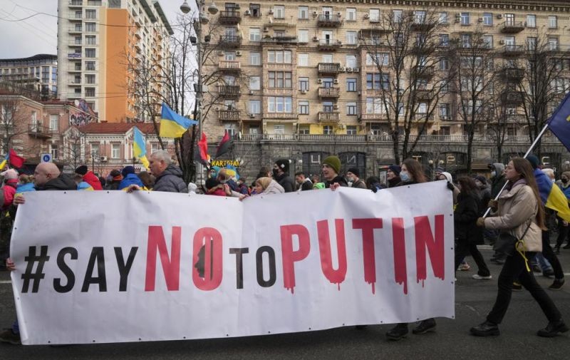 Ukrainians attend a rally in central Kyiv, Ukraine, Saturday, Feb. 12, 2022, during a protest against the potential escalation of the tension between Russia and Ukraine. Russian President Vladimir Putin and U.S. President Joe Biden are to hold a high-stakes telephone call on Saturday as tensions over a possibility imminent invasion of Ukraine escalated sharply and the U.S. announced plans to evacuate its embassy in the Ukrainian capital. (AP Photo)