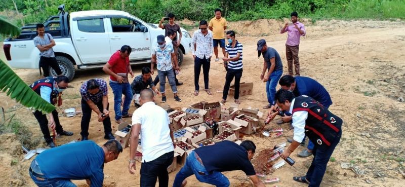 Members of Khaghaboto Youth Front (KYF) and Western Sumi Youth Front (WSYF) destroy seized IMFL in Phishikhu village, Dimapur. (Morung file Photo)