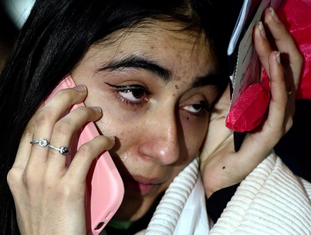 New Delhi: A student who was part of the 2nd batch of Indian nationals evacuated from war-torn  Ukraine, talks over mobile phone upon her arrival at the IGI Airport, in New Delhi, early Sunday, Feb 27, 2022. Air India’s second evacuation flight from Romanian capital Bucharest carrying 250 Indian nationals who were stranded in Ukraine landed at the airport in the early hours of February 27. (PTI Photo/Kamal Kishore)