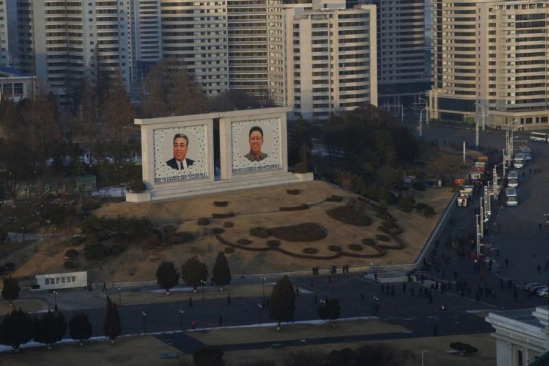 Portraits of late North Korean leaders Kim Il Sung and Kim Jong Il sit in downtown Pyongyang, North Korea on Dec. 19, 2018. North Korea is continuing to steal hundreds of millions of dollars from financial institutions and cryptocurrency firms and exchanges, illicit money that is an important source of funding for its nuclear and missile programs, U.N. experts said in a report quoting cyber specialists. (AP File Photo)