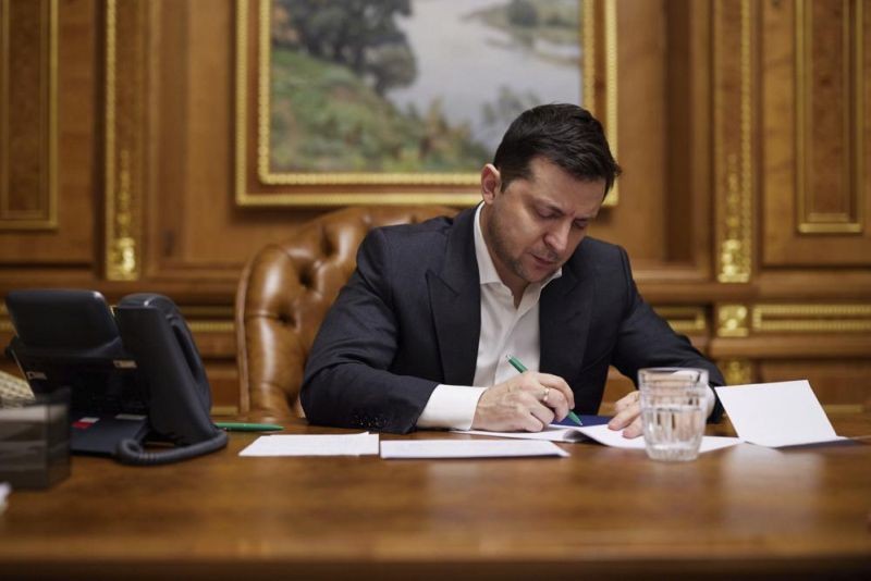 In this handout photo provided by the Ukrainian Presidential Press Office, Ukrainian President Volodymyr Zelenskyy works in his office in Kyiv, Ukraine, Sunday, Feb. 13, 2022. Ukraine's president urged calm amid intensified warnings of a possible Russian invasion within days, saying he had yet to see convincing evidence of that. Zelenskyy's comments came as the U.S. updated its estimate of how many Russian troops are now poised near Ukraine's borders to more than 130,000 Sunday. (AP Photo)