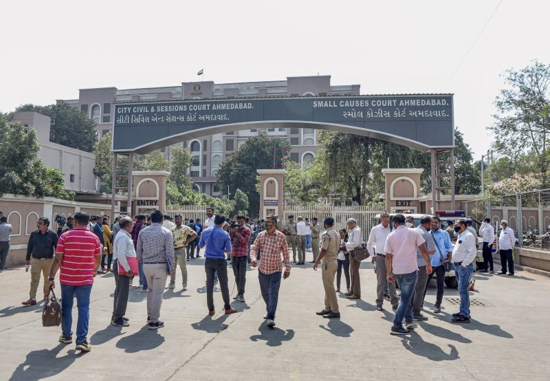 Police and media outside the Session Court during the sentence day of 2008 Ahmedabad Serial Bomb Blast case, in Ahmedabad on February 18, 2022. (PTI Photo)