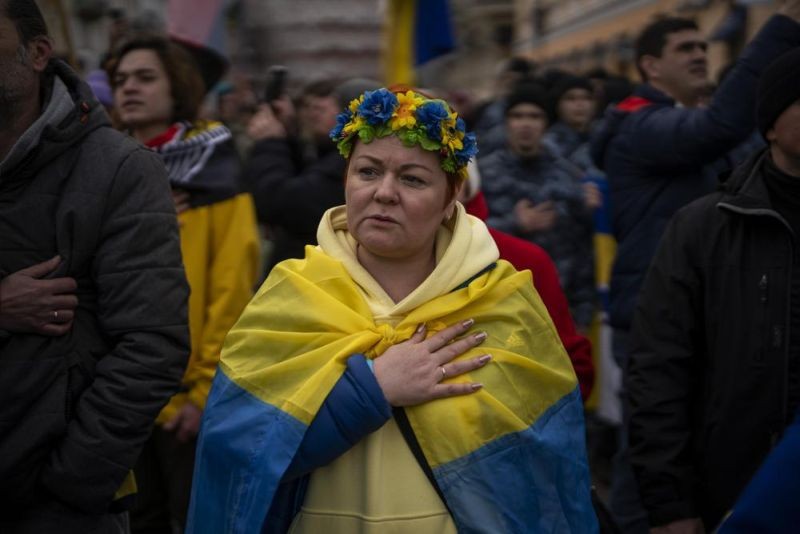 Demonstrators sing the national anthem during a protest in Odessa, Ukraine, Sunday, Feb. 20, 2022.Thousands of people in Odessa marched through the streets of the city in a show of unity on Sunday, marking the date on which, eight years ago, more than a hundred people were killed during Ukraine's Maidan revolution. Waving national flags and placards with slogans such as, 'No Putin, No Cry', people said they had come out to demonstrate against a potential Russian invasion, and said that they were prepared to defend their city if needed. (AP Photo)