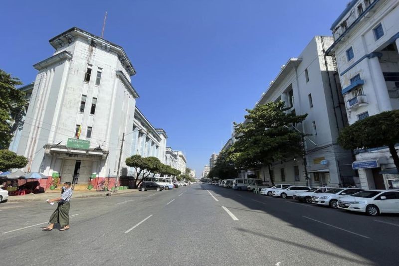 A man crosses an empty Pansodan street in Kyauktada township in Yangon, Myanmar on Tuesday, Feb. 1, 2022. Opponents of military rule in Myanmar on Tuesday marked the one-year anniversary of the army's seizure of power with a nationwide strike to show their strength and solidarity amid concern about what has become an increasingly violent contention for power. (AP Photo)