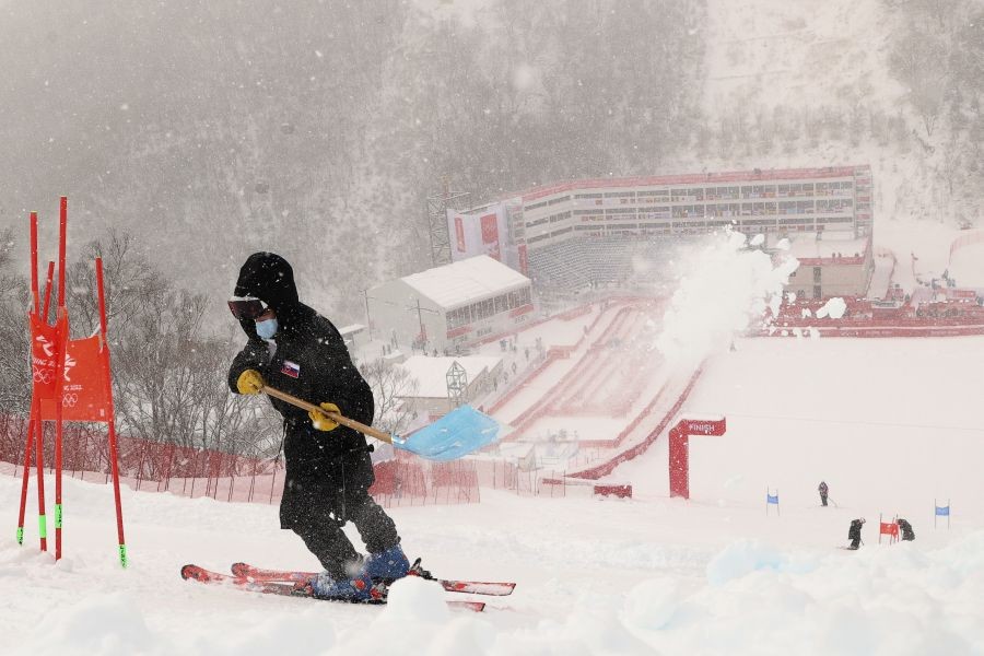 Beijing: A worker clears snow from the course after the second run of the men's giant slalom was delayed due to a heavy snowfall at the 2022 Winter Olympics, Sunday, Feb. 13, 2022, in the Yanqing district of Beijing.AP/PTI
