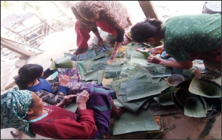 Women sorting through banana leaves to make packaging products as an alternative to single use plastics.