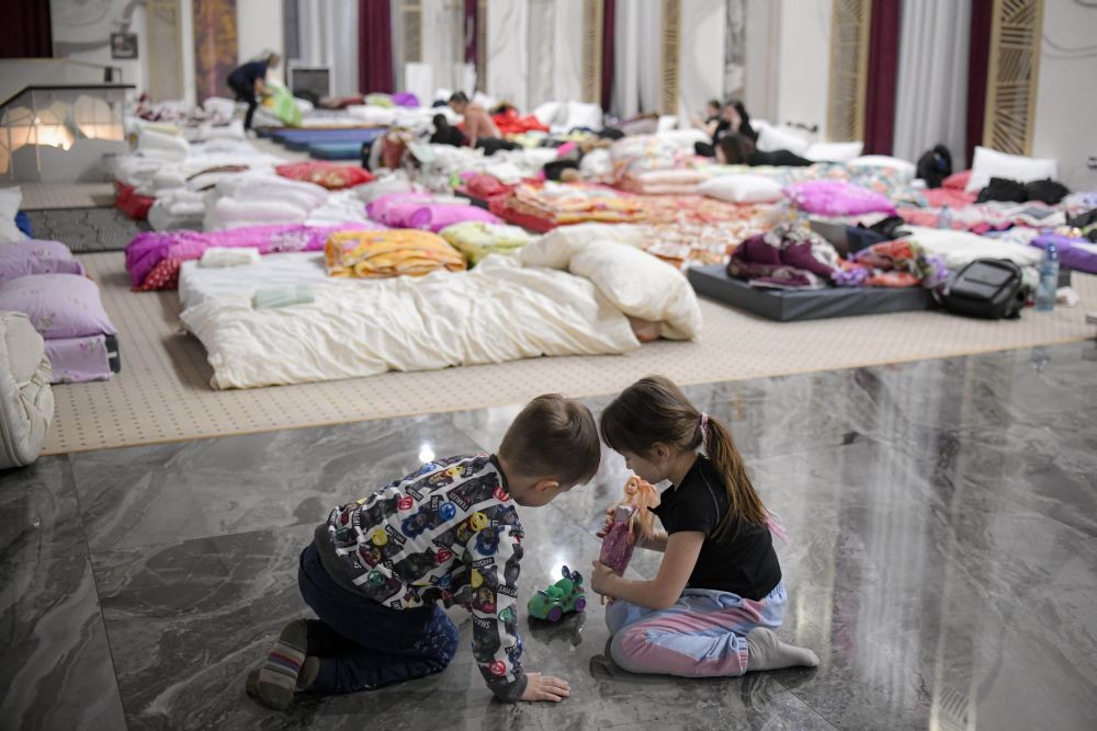Siret: Children who fled the conflict from neighboring Ukraine play on the floor of an event hall in a hotel offering shelter in Siret, Romania, Saturday, Feb. 26, 2022. Romania, which shares around 600 kilometres (372 miles) of borders with Ukraine to the north, is seeing an influx of refugees from the country as many flee Russia's attacks. AP/PTI(